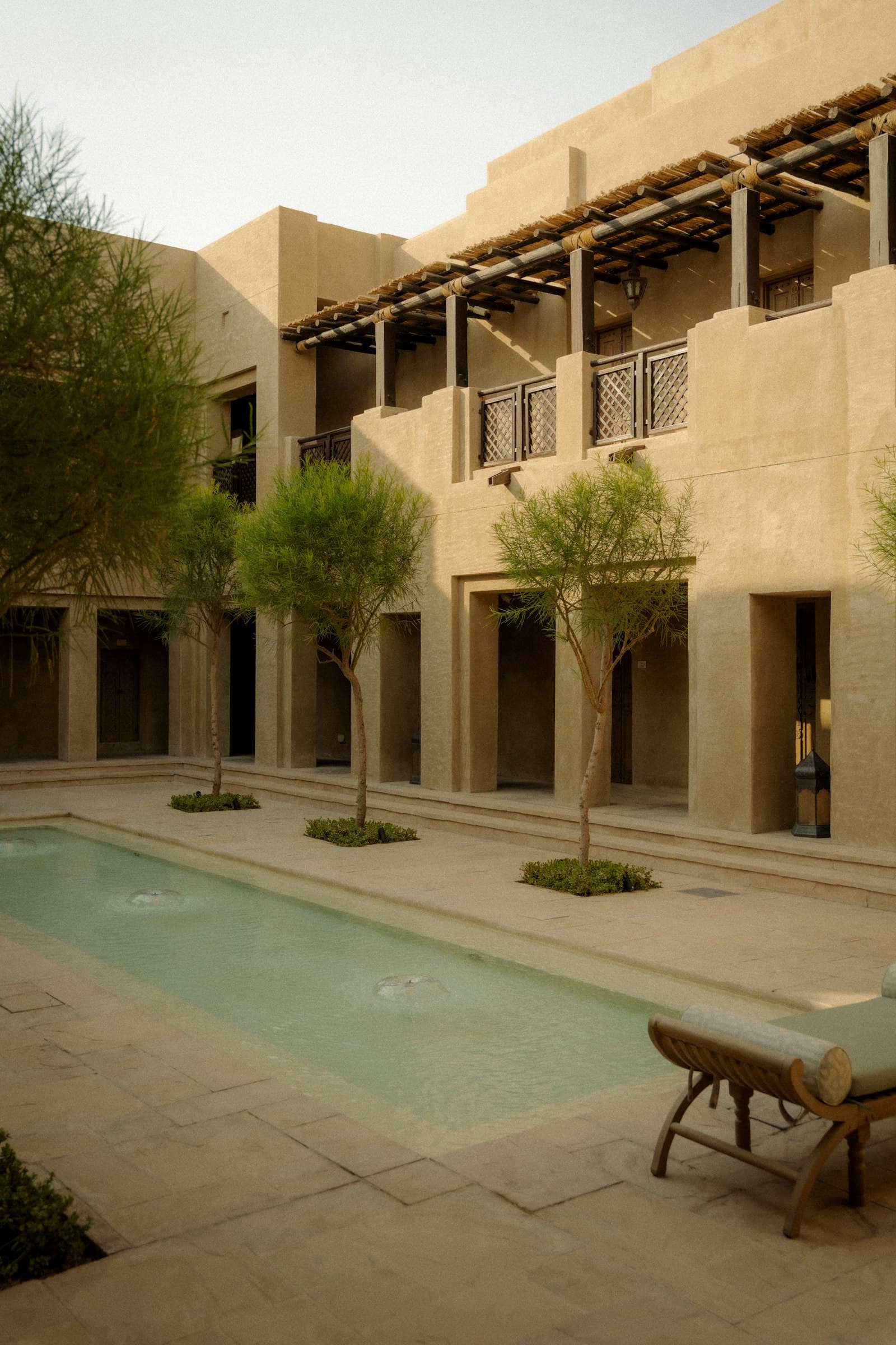 A sunny courtyard with a pool at a low-rise community